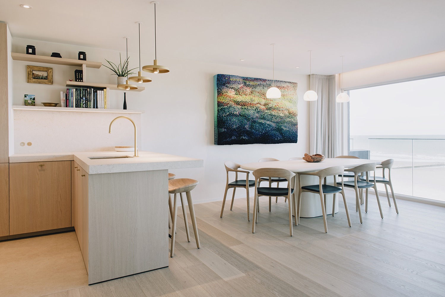 Keukeneiland en eethoek bij de brede raampartij